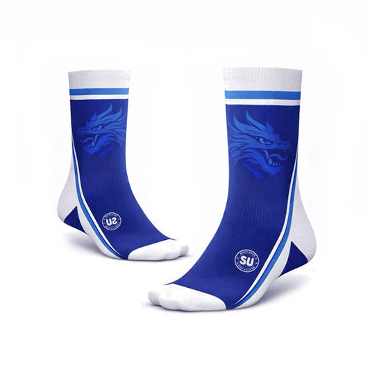 The Southern EITE Mid Socks by Southern Apparel are blue and white, feature a stylized dragon on the sides, white stripes at the top, and offer moisture control for peak match-day performance.