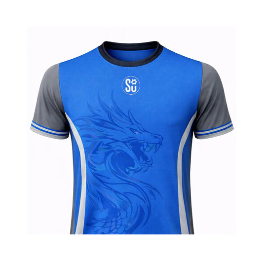 The UMPIRES Elite Uniform by Southern Apparel is a breathable, lightweight blue sports jersey with gray short sleeves, showcasing a large stylized dragon graphic on the front and a small white circular SU logo near the collar.