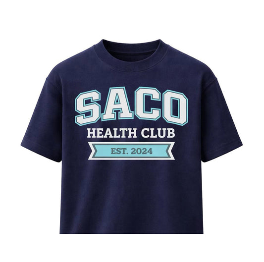 The HERITAGE Short Sleeve Tee by Southern Apparel is a navy blue premium shirt featuring "SACO HEALTH CLUB EST. 2024" in bold white and light blue on the front, crafted from high-quality fabric for comfort—perfect for teamwear or everyday style.