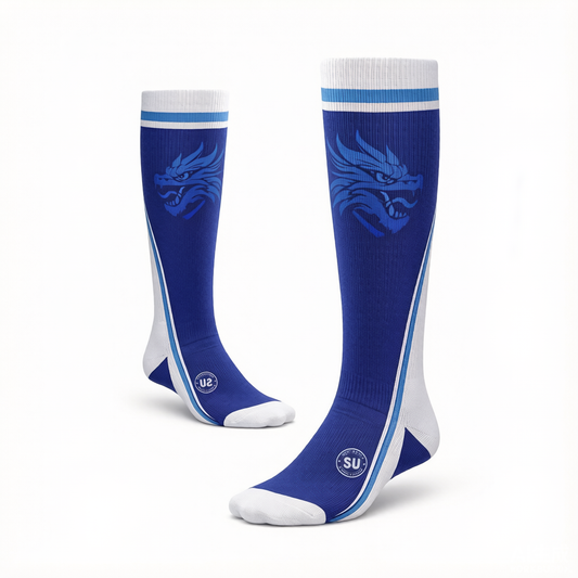 Experience superior match-day performance with Southern Apparel’s Southern ELITE Long Socks—knee-high blue and white athletic socks featuring a striking blue dragon design on the sides and blue and white stripes at the top. Designed for athletes, these socks offer advanced moisture control to keep you comfortable during every game. Displayed on a white background.