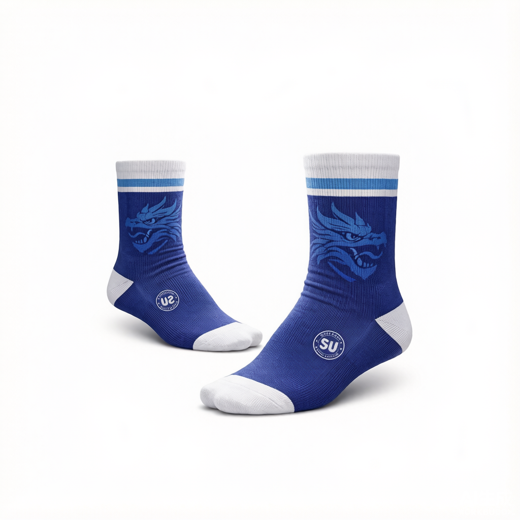 A pair of Southern ELITE Short Socks by Southern Apparel in blue, featuring white toes, heels, and cuffs, with a stylized dragon face on the sides and a circular logo near the ankles. Designed for match-day performance and enhanced moisture control, the socks are displayed against a white background.