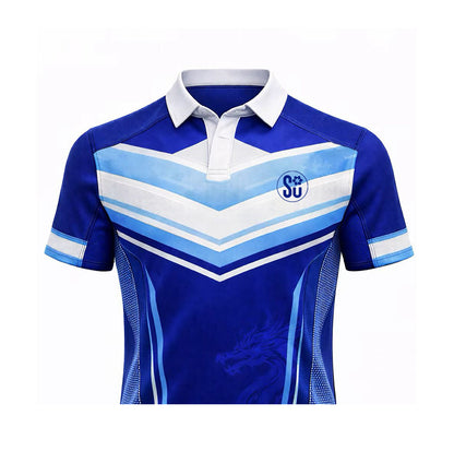 Introducing the Southern FOUNDATION Short Sleeve Jersey by Southern Apparel: blue with white and light blue chevrons, a white collar, SU logo on the chest, and a subtle dragon design. Coming soon—don’t miss this bold new look!.