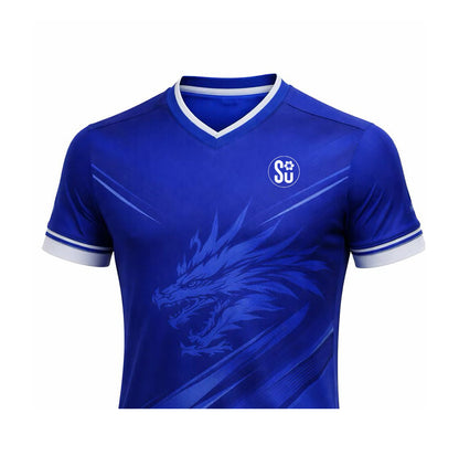 The Southern Apparel Southern SOCCER ELITE Short Sleeve Jersey features a blue design with white trim, a stylized dragon graphic, circular SU logo on the left chest, and lightweight fabric for top match day performance.